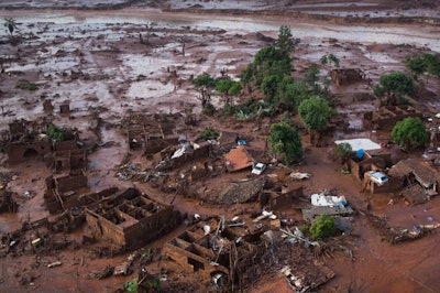 In this Nov. 6, 2015 photo, homes lay in ruins after two dams burst the previous day, flooding the small town of Bento Rodrigues in Minas Gerais state, Brazil. Searchers used small airplanes and a drone to look for missing people.