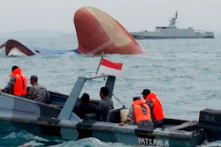 Indonesia rescuers approach the sunken freighter MV Thorco Cloud in the Singapore Strait off the Indonesian island of Batam on Thursday, December 17. The freighter sank after colliding with a tanker on Wednesday. Rescuers saved six crewmen from choppy waters while six others are still missing. (AP Photo)
