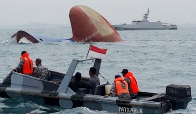 Indonesia rescuers approach the sunken freighter MV Thorco Cloud in the Singapore Strait off the Indonesian island of Batam on Thursday, December 17. The freighter sank after colliding with a tanker on Wednesday. Rescuers saved six crewmen from choppy waters while six others are still missing. (AP Photo)