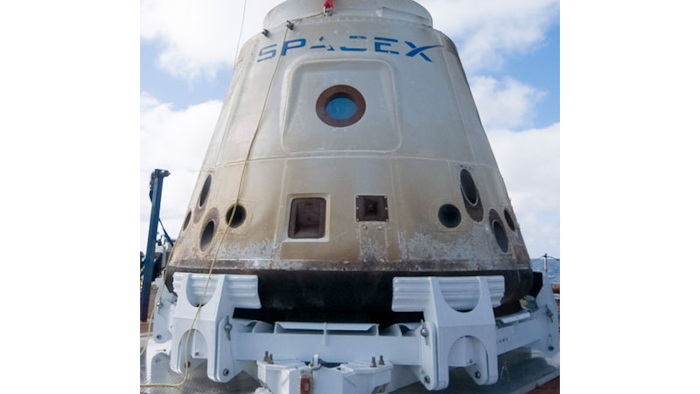 The Dragon spacecraft, in excellent condition after its 50,000 mile mission, rests in its cradle for the 500 mile ride back to Los Angeles.