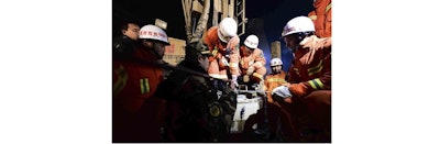 In this Dec. 28, 2015 photo provided by China's Xinhua News Agency, rescuers try to contact the trapped people at a collapsed mine in Pingyi County, east China's Shandong Province. Chinese state media said rescuers have found eight surviving miners who have been trapped for five days by a collapse at a gypsum mine in eastern China. (Guo Xulei/Xinhua News Agency via AP)