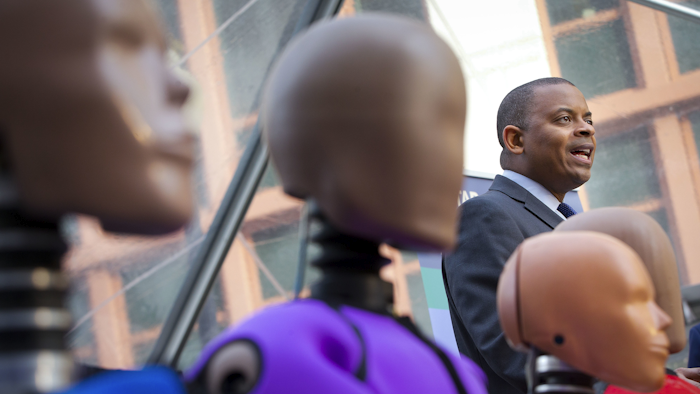 Transportation Secretary Anthony Foxx, with new crash test dummies called 'THOR', speaks during the announcement for plans to update its safety rating system for new cars to include whether the car has technology to avoid crashes, in addition to how well it protects occupants in accidents in Washington, Tuesday, Dec. 8, 2015. (AP Photo/Pablo Martinez Monsivais)
