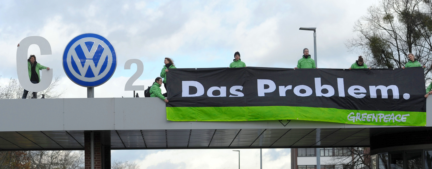 In this Nov. 9, 2015, file photo, Greenpeace activists stand with 'CO2' formed with the VW logo and a banner that reads 'the problem' above the Volkswagen factory gate in Wolfsburg, Germany. California air quality regulators on Wednesday, Nov. 25, 2015, demanded a recall of up to 16,000 additional Volkswagen, Audi and Porsche diesels as the Volkswagen emissions scandal widened. (Peter Steffen/dpa via AP, File)