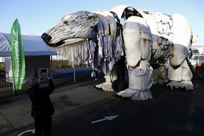 A two-story-high, mechanically operated polar bear called Aurora is installed by activists from Greenpeace into the conference venue, to represent everyone hoping in the next 72 hours during the COP21. (AP Photo/Francois Mori)