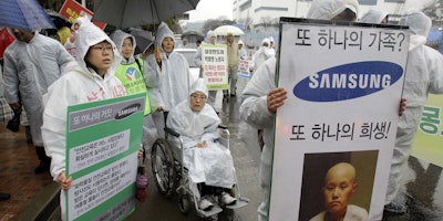 Samsungβs hopes of ending years of acrimony and bad publicity over whether its semiconductor factories caused cancer have hit a hitch: some sickened workers and their families say theyβll never accept its highly conditional offer of financial assistance. (AP Photo)