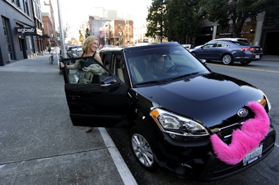 Katie Baranyuk gets out of a car driven by Dara Jenkins, a driver for the ride-sharing service Lyft, after getting a ride to downtown Seattle. (AP Photo/Ted S. Warren, File)