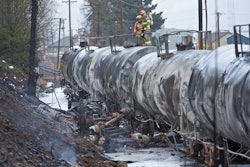 The remains of a fuel tanker truck that crashed into railroad cars is seen near the St. Johns Bridge in Portland, Ore., Sunday, Dec. 13, 2015. (AP Photo/Craig Mitchelldyer)