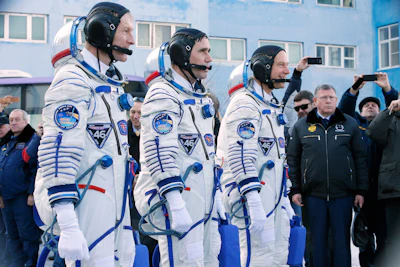 British astronaut Tim Peake, left, Russian cosmonaut Yuri Malenchenko, center, and U.S. astronaut Tim Kopra, members of the main crew of the expedition to the International Space Station (ISS), report to members of the State Committee prior to the launch of Soyuz TMA-19M space ship at the Russian leased Baikonur cosmodrome, Kazakhstan, Tuesday, Dec. 15, 2015. (AP Photo/Dmitry Lovetsky, Pool)