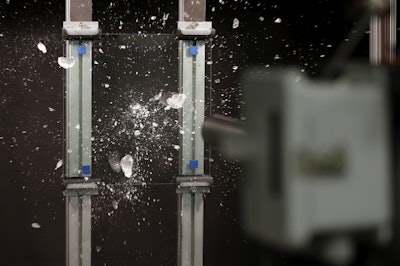 An ice ball breaks up after hitting a sample of Corning Inc.'s Gorilla Glass at the Dearborn Development Center in Dearborn, Mich. Ford says the glass is more durable and scratch-resistant than traditional glass. It’s also about 30 percent lighter, which saves fuel and improves the vehicle’s handling. (AP Photo/Carlos Osorio)