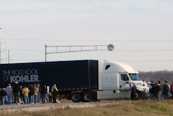 Hundreds of Union members picket at the gates of the Kohler Co., Monday, Nov. 16, 2015, in Kohler, Wis. Workers have taken issue with what they call an inadequate pay increase, higher health care costs and the continuation of a two-tier wage scale. (AP Photo/Greg Moore)