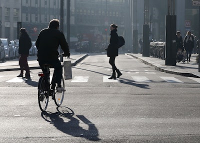 A cyclist pedals in downtown Milan, Italy, Monday, Dec. 28, 2015. Milan has ordered Monday a no-car day to combat pollution, which has hit unhealthy levels for weeks mainly because no rain has fallen to wash away the smog. (AP Photo/Antonio Calanni)