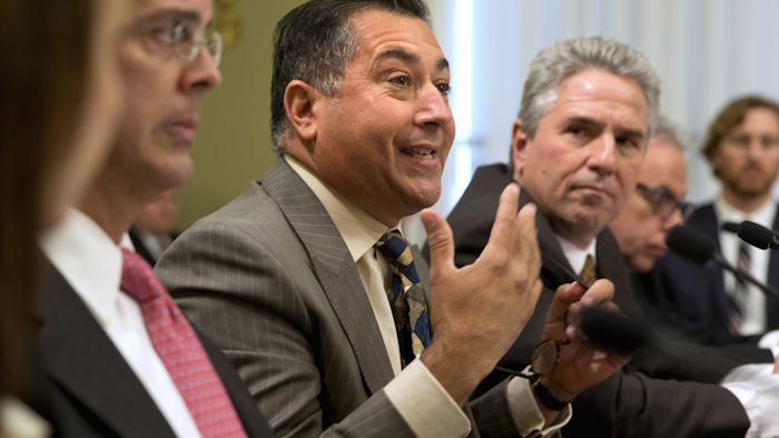 Carlos Rivera Vélez, with the Puerto Rico Manufacturers Association, center, testifies on Capitol Hill in Capitol Hill in Washington, Tuesday, Jan. 12, 2016, before the House Energy and Mineral Resources subcommittee hearing on the financial situation of Puerto Rico's Electric Power Authority. Officials say Puerto Rico's troubled power company does not have the money to make more than $1 billion in payments due to creditors through July unless a restructuring deal is approved. (AP Photo/Jacquelyn Martin)