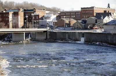 In this Thursday, Jan. 21, 2016 photo, the Hoosic River runs through the village of Hoosick Falls, N.Y. Federal regulators have warned residents of the upstate New York factory village near the Vermont border not to drink water from municipal wells, and a plastics plant has agreed to supply bottled water and pay for a new filtration system. (AP Photo/Mike Groll)