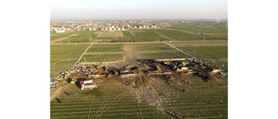 Emergency personnel walk through the rubble of a destroyed fireworks factory, as seen from an aerial view, in Tongxu county in central China's Henan province Thursday, Jan. 14, 2016. Several people were killed on Thursday in an explosion at the factory, just weeks ahead of the Chinese New Year authorities said. (Chinatopix via AP)