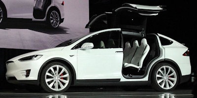 The Tesla Model X is shown with its 'falcon wing' doors open during a 2015 market launch event. (Image: Steve Jurvetson via his Flickr account)