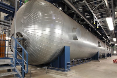 This massive silver cigar called the feedwater tank holds water before it enters the boiler. The tank can store 100,000 gallons of water heated high above its boiling point to 380 degrees Fahrenheit (193.3 Celsius). To improve efficiency, the plant extracts some of the steam from the water-steam cycle to reheat it. Image credit: GE Power