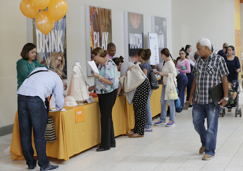 In this Tuesday, Oct. 6, 2015, file photo, job applicants fill out forms during a job fair at Dolphin Mall in Miami. On Tuesday, Jan. 26, 2016, the Labor Department reports on state unemployment rates for December 2015. (AP Photo/Wilfredo Lee, File)