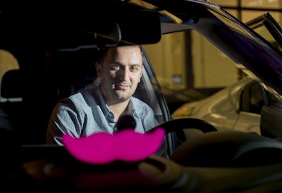 Lyft co-founder John Zimmer displays his company's 'glowstache.' (AP Photo/Noah Berger, File)