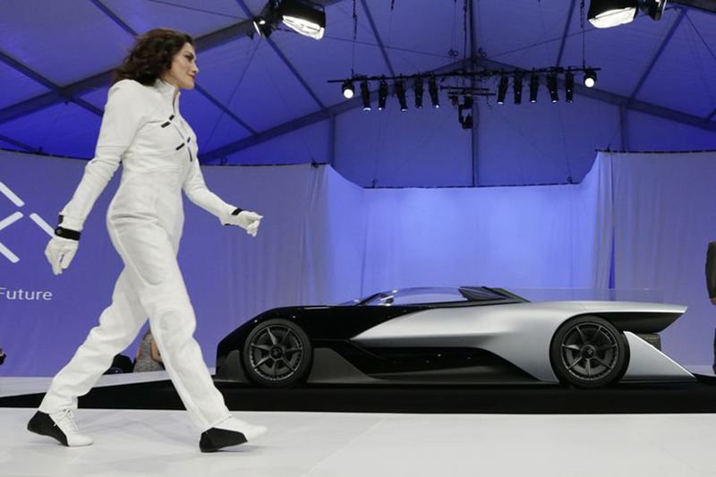 A driver walks in front of the FFZero1 by Faraday Future. (AP Photo/Gregory Bull)