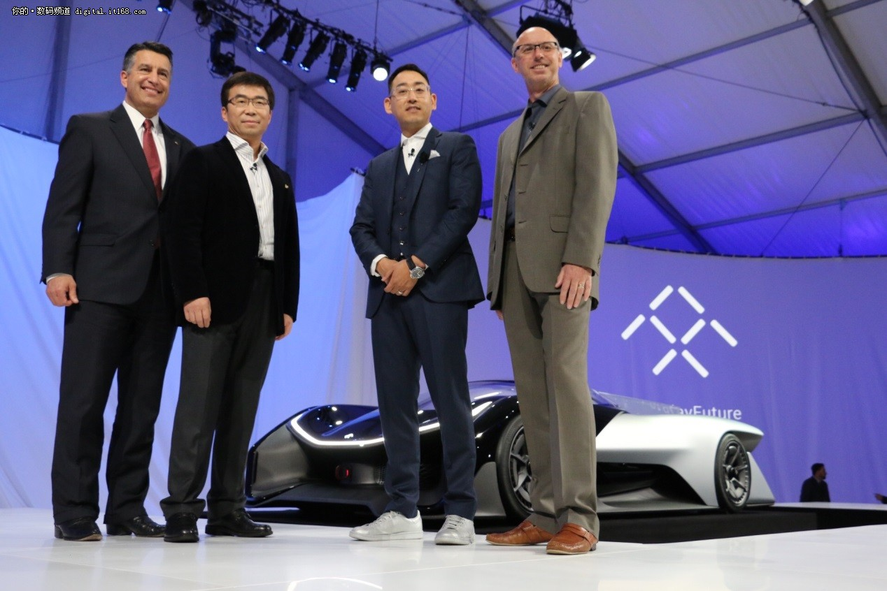 Nevada Gov. Brian Sandoval, left, poses for a photo in front of the FFZero1 by Faraday Future, alongside members of the Faraday Future team. (AP Photo/Gregory Bull)