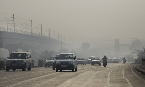 Vehicles move through morning smog on the first day of a two-week experiment to reduce the number of cars to fight pollution in New Delhi, India. (AP Photo/Altaf Qadri)