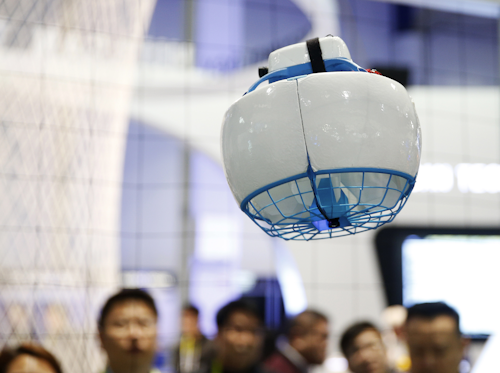 The Fleye drone flies at Fleye booth during CES International, Thursday, Jan. 7, 2016, in Las Vegas. The single propeller of the drone is enclosed for safety. (AP Photo/John Locher)