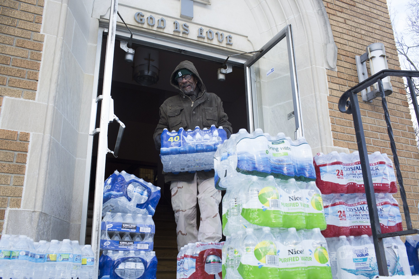 Maurice Rice organizes cases of water at the Joy Tabernacle Church on Monday, Jan. 11, 2016, in Flint, Mich. (Conor Ralph/The Flint Journal-MLive.com via AP)