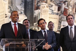 U.S. Transportation Secretary Anthony Foxx, left, listens to a question with auto executives at the North American International Auto Show in Detroit. (AP Photo/Paul Sancya)