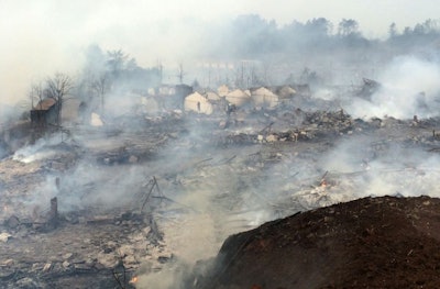 Smoke rises over the rubble of a fireworks factory after an explosion near Shangrao in southern China's Jiangxi province Wednesday Jan. 20, 2016. (Chinatopix via AP) CHINA OUT