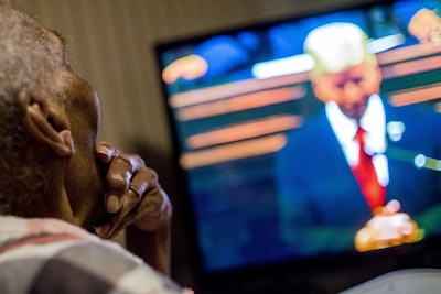 Flint resident Ollie Peterson, 87, strokes her chin while listening to Michigan Gov. Rick Snyder deliver his State of the State address on television Tuesday, Jan. 19, 2016, at their home in Flint. (Jake May/The Flint Journal-MLive.com via AP)