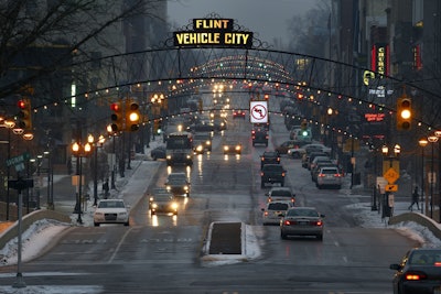 Vehicles make their way through downtown Flint, Mich., Thursday, Jan. 21, 2016. Residents in the former auto-making hub — a poor, largely minority city — feel their complaints about lead-tainted water flowing through their taps have been slighted by the government or ignored altogether. For many, it echoes the lackluster federal response to New Orleans during Hurricane Katrina in 2005. (AP Photo/Paul Sancya)