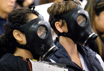 Protestors wearing gas masks attend a hearing over a gas leak at the southern California Gas Company's Aliso Canyon Storage Facility near the Porter Ranch section of Los Angeles. (AP Photo/Richard Vogel, File)