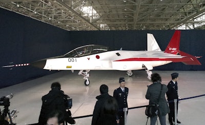 The first domestically-made stealth aircraft, X-2, is shown to the media at Nagoya Airport in Toyoyama town, central Japan, Thursday, Jan. 28, 2016. The demonstration plane is expected to make its maiden flight sometime after mid-February. A Defense Ministry official said the technology will give Japan the option of developing its own stealth fighter jets in the future. (AP Photo/Emily Wang)