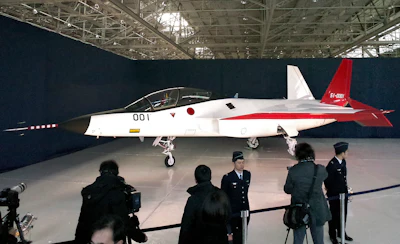 The first domestically-made stealth aircraft, X-2, is shown to the media at Nagoya Airport in Toyoyama town, central Japan, Thursday, Jan. 28, 2016. The demonstration plane is expected to make its maiden flight sometime after mid-February. A Defense Ministry official said the technology will give Japan the option of developing its own stealth fighter jets in the future. (AP Photo/Emily Wang)