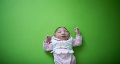 Sophia, who is two weeks old and was born with microcephaly, sleeps before her physical therapy session at the Pedro I hospital in Campina Grande, Paraiba state, Brazil, Friday, Feb. 12, 2016. The Zika virus, spread by the Aedes aegypti mosquito, is suspected to be linked with occurrences of microcephaly in new born babies, but no link has been proven yet. (AP Photo/Felipe Dana)