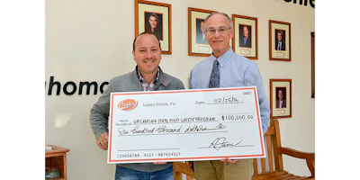 John Patrick Lopez, chief operating officer for Lopez Foods, presents a check for $100,000 to Roy Escoubas, director for OSU's Robert M. Kerr Food & Agricultural Products Center, to support the university’s food safety program.