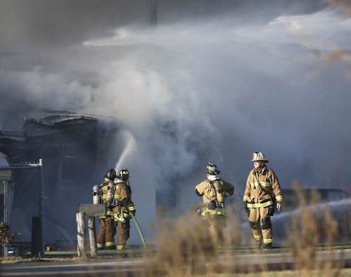 Firefighters work to extinguish a fire at Viking Wholesale after it had spread from the neighboring Bluegrass Stockyards on Saturday, Jan. 30, 2016, in Lexington, Ky. Lexington Fire Department spokesman Joe Best said Saturday the blaze was one of the largest he has seen in his 25 years with the department.(AP Photo/David Stephenson)