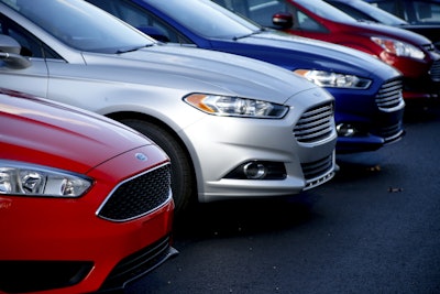 In this Thursday, Nov. 19, 2015, photo, a row of new Ford Fusions are for sale on the lot at Butler County Ford in Butler, Pa. On Tuesday, Feb. 2, 2016, the major automakers report sales figures for January. (AP Photo/Keith Srakocic)