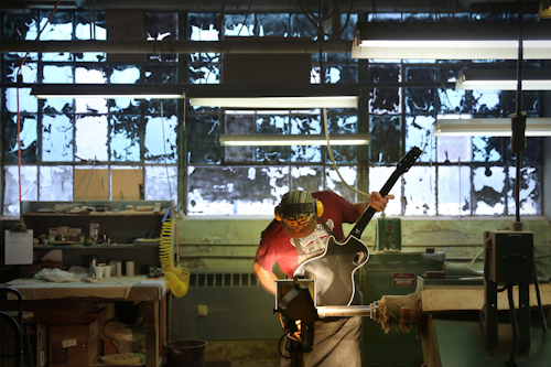 In this March 25, 2015, file photo, Willard Fenton-Miller polishes a Heritage guitar at a factory in Kalamazoo, Mich. On Thursday, Feb. 4, 2016, the Labor Department issues preliminary data on productivity in the fourth quarter of 2015. (Mark Bugnaski/Kalamazoo Gazette-MLive Media Group via AP)