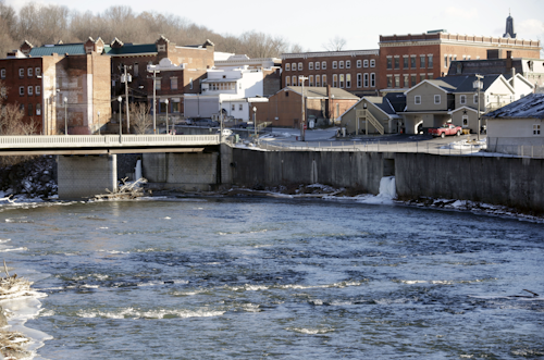 In this Jan. 21, 2016 file photo, the Hoosic River runs through the village of Hoosick Falls, N.Y. New York regulators say Saint-Gobain Performance Plastics and Honeywell International are required to pay for the investigation and cleanup of a toxic chemical in the upstate village’s drinking water. (AP Photo/Mike Groll, File)