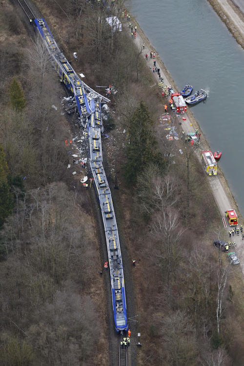 In this Feb. 9, 2016 file picture an aerial view of rescue teams at the site where two trains collided head-on near Bad Aibling, Germany is pictured. Prosecutors said at a press conference Tuesday Feb. 16, 2016, they believe the head-on train crash in southern Germany last week was caused by “human error” on the part of the train dispatcher. Eleven people died and scores were injured when two commuter trains slammed into each other on a single-line track near Bad Aibling, 60 kilometers (40 miles) southeast of Munich. Chief prosecutor Wolfgang Giese says his office has opened a criminal investigation against the 39-year-old dispatcher. (AP Photo/Matthias Schrader,file)