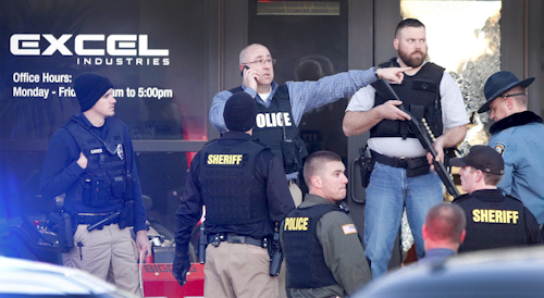 Police guard the front door of Excel Industries in Hesston, Kan., Thursday, Feb. 25, 2016, where a gunman killed three and injured 14. (Fernando Salazar/The Wichita Eagle via AP)
