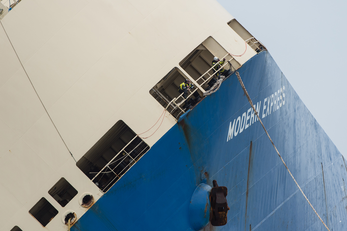 Rescue workers control the cable on the 164-meter (538-foot) cargo ship'Modern Express'as it is towed while it drifted off the coast of France. (Loic Bernardin/ Prefecture Maritime Atlantique via AP)