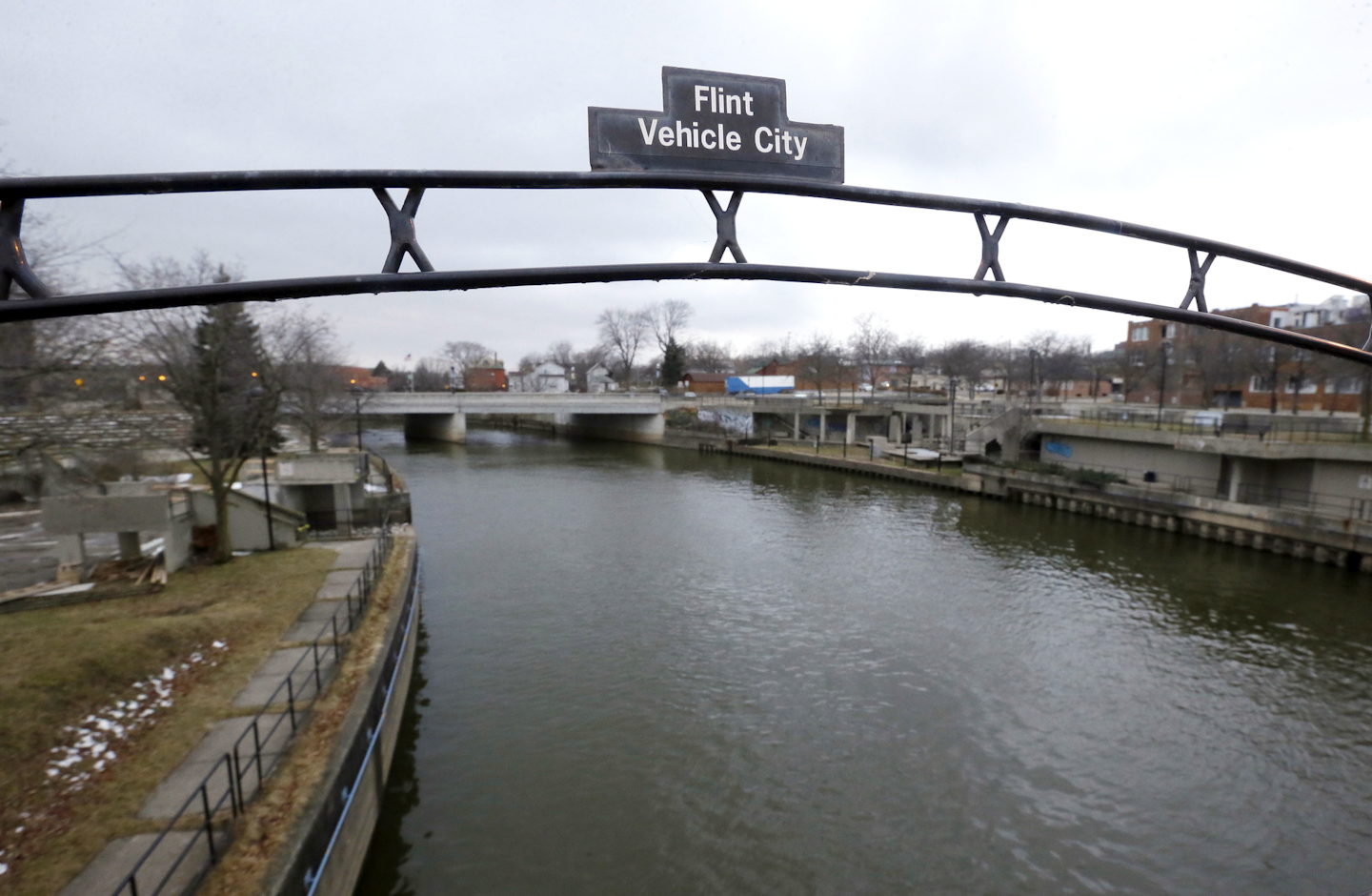 This Jan. 26, 2016 file photo shows a sign over the Flint River noting Flint, Mich., as Vehicle City. (AP Photo/Carlos Osorio, File)
