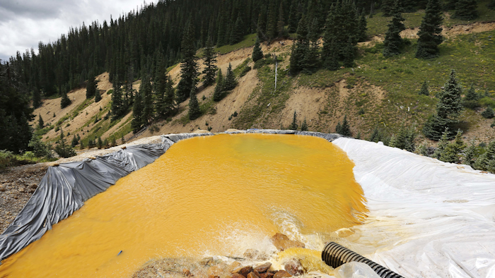 In this Wednesday, Aug. 12, 2015, file photograph, water flows through a series of retention ponds after a spill at the Gold King mine near Silverton, Colo. (AP Photo/Brennan Linsley, file)