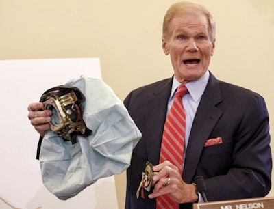 Senate Commerce Committee member Sen. Bill Nelson, D-Fla. holds an example of the defective airbag made by Takata of Japan that has been linked to multiple deaths and injuries in cars driven in the U.S. (AP Photo/J. Scott Applewhite, File)