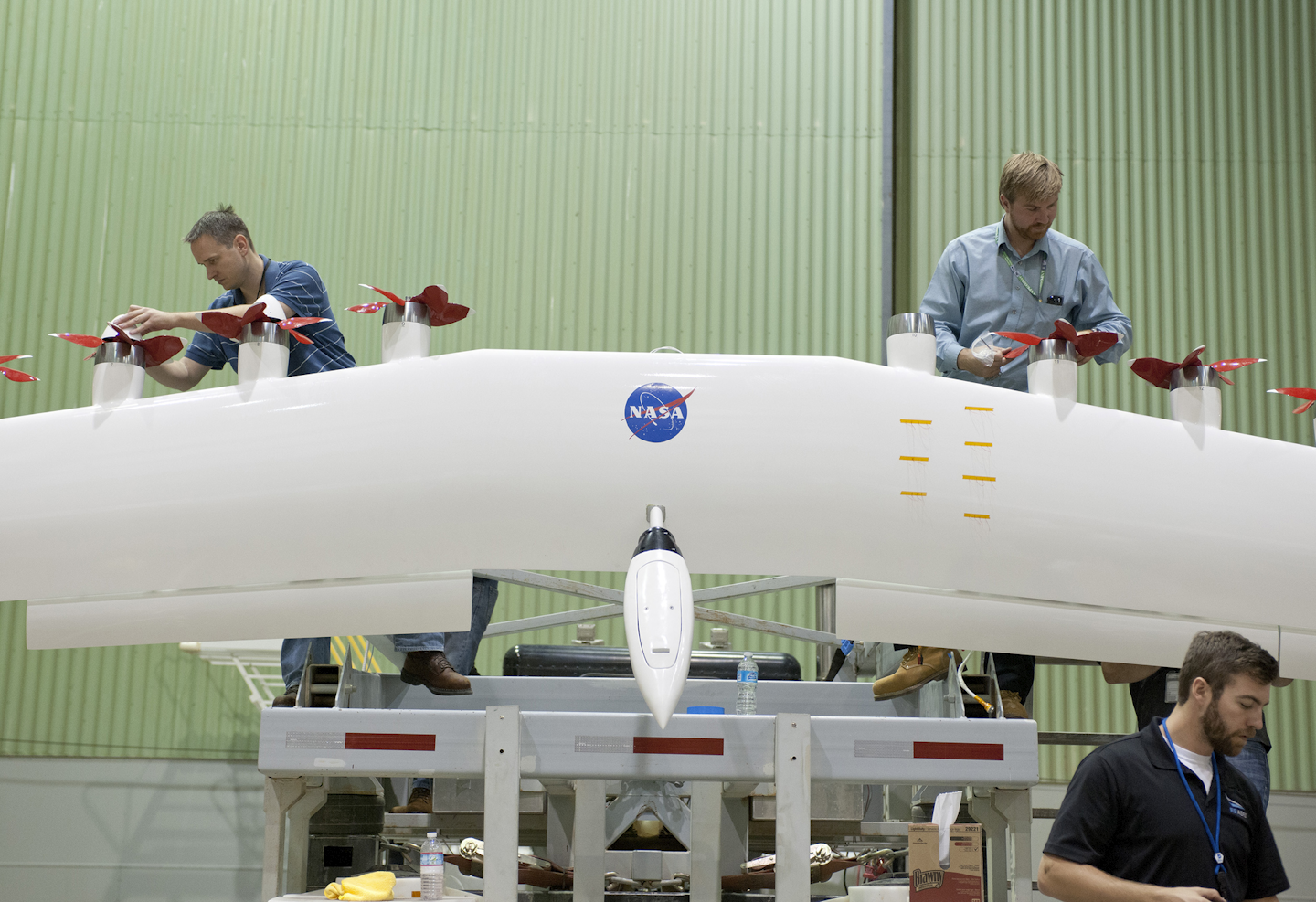 Engineers work on a wing with electric motors that is part of an integrated experimental testbed. (Image credit: NASA/Tom Tschida)