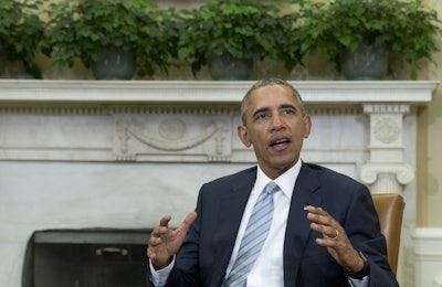 President Barack Obama talks to media in the Oval Office of the White House, in Washington, Wednesday, Feb. 17, 2016, at the bottom of a meeting, where he announced that former IBM CEO Sam Palmisano, former National Security Adviser Tom Donilon are being appointed as the Chair and Vice Chair, respectively, of the Commission on Enhancing National Cybersecurity. (AP Photo/Carolyn Kaster)