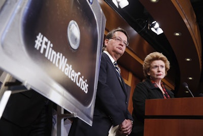 Sen. Gary Peters, D-Mich., left, and Sen. Debbie Stabenow, D-Mich., listen to a question as they discuss proposed legislation to help Flint, Mich. with their current water crisis, Thursday, Jan. 28, 2016, during a news conference on Capitol Hill in Washington. (AP Photo/Alex Brandon)