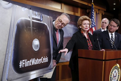 Sen. Debbie Stabenow, D-Mich., second from left, accompanied by, from left, Sen. Charles Schumer, D-N.Y., Sen. Bob Casey, D-Pa., and Sen. Gary Peters, D-Mich., discusses proposed legislation to help Flint, Mich. with their current water crisis, Thursday, Jan. 28, 2016, during a news conference on Capitol Hill in Washington. (AP Photo/Alex Brandon)